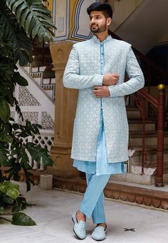 Faux Georgette Sherwani in Light Blue. This Readymade attire with Satin Lining is Enhanced with Pockets, Resham, Sequins Work. Crafted in Chinese Collar Neck and Full Sleeve. Available with an Art Silk Aligarhi Pant in Light Blue and an Art Silk Inner Kurta in Light Blue. Do note: Footwear shown in the image is for presentation purposes only. Half to one inch may vary in measurement. (Slight variation in actual color vs. image is possible) We sell all kinds of menswear. Mens Kurta | Mens Kurta P Engagement Outfits Indian, Indian Wedding Suits Men, Blue Sherwani, Mens Wedding Suits, Indian Jackets, Sherwani For Men Wedding