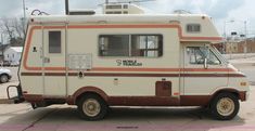 an old camper is parked on the side of the road