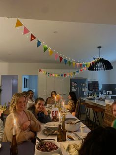 a group of people sitting around a dinner table