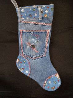 an old pair of jeans has been decorated with patches and snowflakes on it