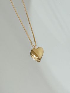 In my Heart Gold locket Keep your loved ones close to your heart in this mini heart locket made in 14k Gold filled. Small photos can be cut out and put inside the locket. Can be purchased with a very sleek 14k Gold filled box chain necklace that is perfect to wear as is. The chain is a tiny baby box chain, and it moves subtly on your neck to catch the light. Staple for everyday. + 14k Gold filled 25x20mm heart + 0.6mm chain + Comes in a box. + Please allow 3-5 business days to ship + Please note Gold Necklace Locket, Small Gold Locket, Gold Heart Locket Necklace, Gold Lockets, Locket Gold, Gold Heart Locket, Gold Locket Necklace, Heart Locket Necklace, Baby Box