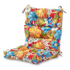 an outdoor chair cushion with colorful flowers on the front and back, attached to a white background