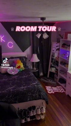 the room is decorated in black and white with neon lights on the wall above the bed