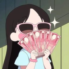 a woman with sunglasses holding up money in front of her face