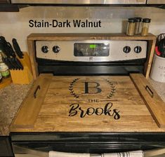 a wooden cutting board sitting on top of an oven door with the words b in it