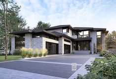 a large modern house with lots of windows and stone work on the front entrance area