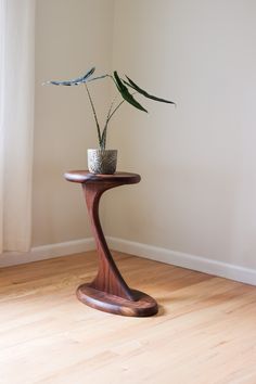 a wooden table with a potted plant on it