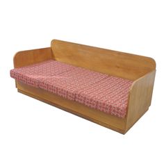 a wooden bench with a red and white patterned seat cover on it's back