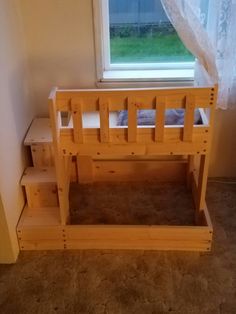 a wooden bunk bed sitting next to a window