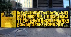 a large yellow and black sign on the side of a building with words written all over it