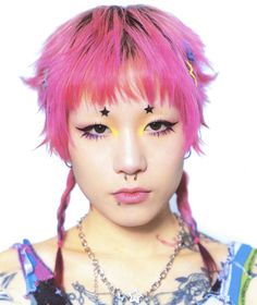 a woman with pink hair and piercings on her face