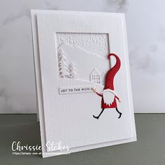 a white card with a santa clause on it and the words joy to the world