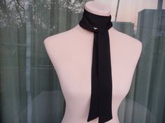 This skinny black scarf is made by 100% silk satin, and creates a beautiful and lovely picture for you to wear with your favorite outfit.  It has the perfect length to wear in different ways like as a bow, a skinny scarf or tie around your neck or on your head. It can be use as a headband and choker necklace also. So many ways to wear it!   Size: 3,5cm x 1,38 cm (28 euro) 5 cm x 138 cm (35 euro) 3,5 cm x 1,80 cm (35 euro) 5 cm x 1,80 cm (42 euro) 7 cm x 1,80 cm (49 euro) Wash gently in cold water. It's a wonderful gift choice for everyone. Check also my other silk scarves: https://www.etsy.com/shop/ArtTetisCollections Ready to ship. Thank you for visiting my shop. Silk Party Ties, Elegant Party Scarf, Elegant Adjustable Scarf Neckwear, Elegant Black Tie Scarf, Formal Scarf Neckwear, Elegant Adjustable Ribbon Neckwear, Elegant Silk Scarf With Ribbon, Elegant Black Silk Scarves, Elegant Tie Neck Silk Scarf