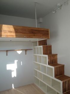 an empty room with white walls and wooden stairs