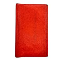 a red leather wallet on a white background