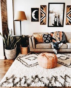 a living room filled with lots of furniture and pictures on the wall above it's couch