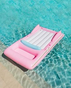 an inflatable boat floating on top of a pool next to a swimming board