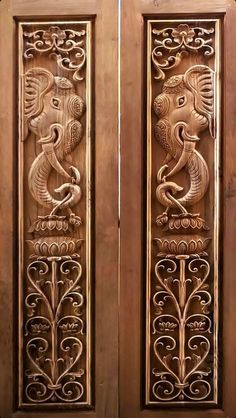 two wooden doors with decorative carvings on them