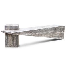 a concrete bench sitting on top of a white floor