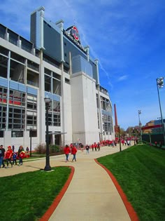 people are walking in front of the stadium