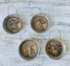 three metal ornaments with animals on them