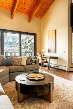 a living room filled with furniture and a flat screen tv mounted to the side of a wall