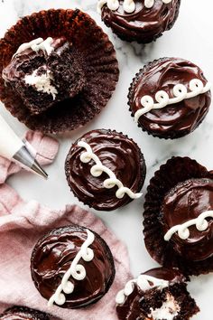 chocolate cupcakes with white frosting and football decorations