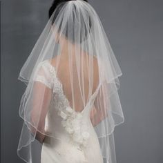 the back of a bride's veil with flowers on it