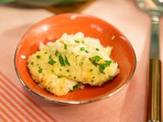 a bowl filled with mashed potatoes and garnished with parsley on top