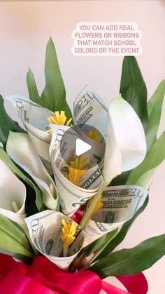 a bouquet of flowers with money wrapped around it