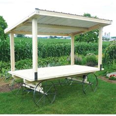 an outdoor picnic table with wheels in the grass