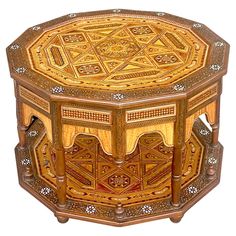 an ornate wooden box with intricate carvings on the top and sides, is shown in full color