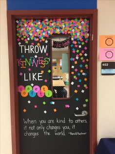 a classroom door decorated with confetti and writing