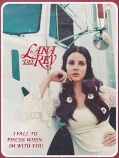 a woman standing in front of a semi truck with the words lana del ray on it