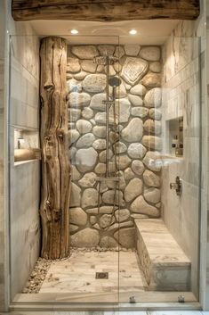 a walk in shower sitting next to a stone wall and wooden beams on the ceiling