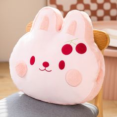 a pink stuffed animal sitting on top of a chair