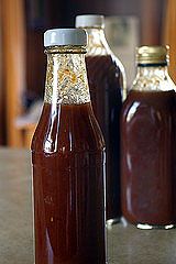 two bottles filled with liquid sitting on top of a table