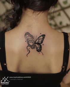 a woman with a butterfly tattoo on her back