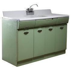 an old green sink cabinet with a faucet