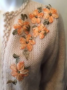 a sweater with orange flowers on it