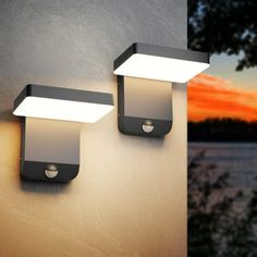 two outdoor lights on the side of a wall