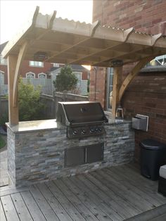 an outdoor bbq and grill on a wooden deck