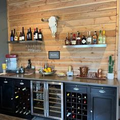 a bar with wine bottles and glasses on it