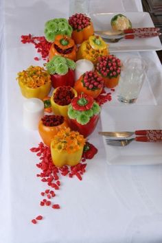 the table is set with many different types of desserts on it, including cupcakes