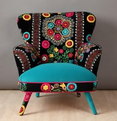 an upholstered chair with colorful flowers on it