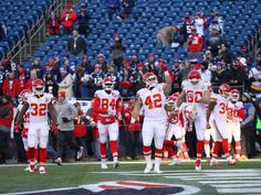 the football players are running onto the field