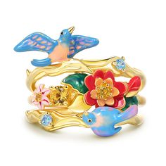 an assortment of rings with flowers and birds on them, all in yellow gold plated metal