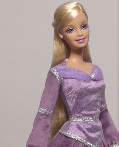 a barbie doll wearing a purple dress and tiara