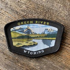 the wyoming green river patch is shown on a wooden surface