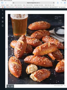 breads and pastries on a table next to a glass of beer